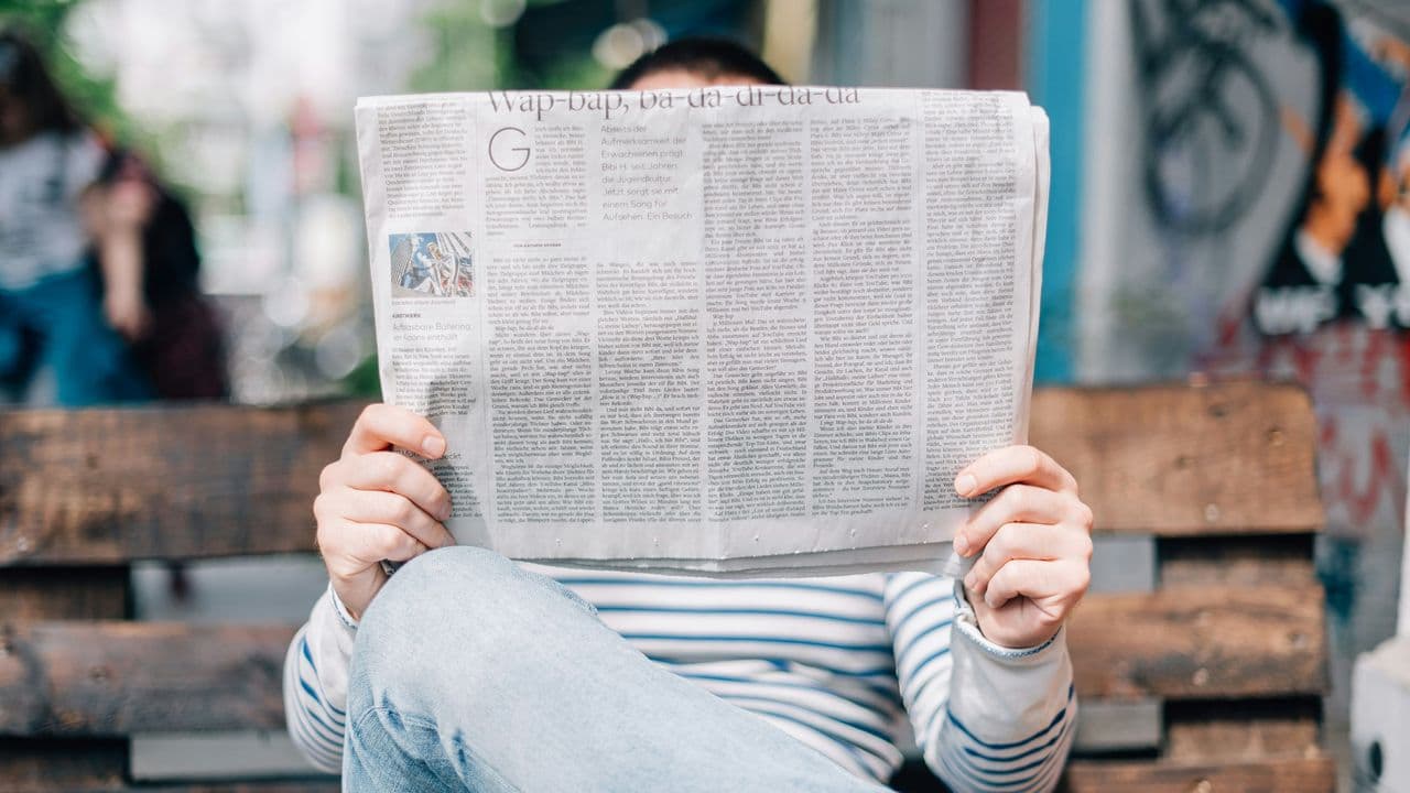 Persona leyendo un periódico